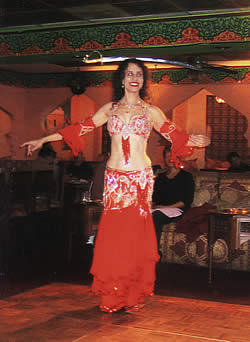 [Bonita dancing in red costume on stage]
