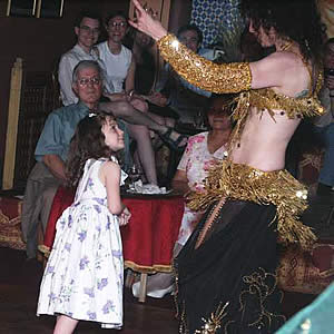 [photo of Bonitia dancing before a little girl]